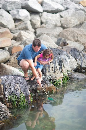 pictures of dad and daughter fishing - Father and daughter fishing from rocks Stock Photo - Premium Royalty-Free, Code: 614-06973754