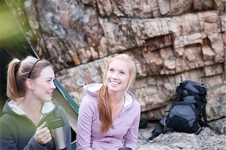 Two girls sitting outside tent Stock Photo - Premium Royalty-Free, Code: 614-06973814