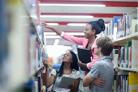 Students in library with digital tablet Stock Photo - Premium Royalty-Free, Code: 614-06973829