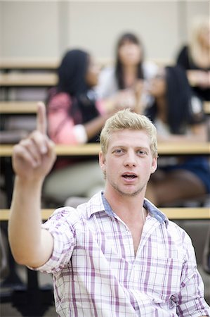 Male student in lecture with arm raised Foto de stock - Sin royalties Premium, Código: 614-06973843