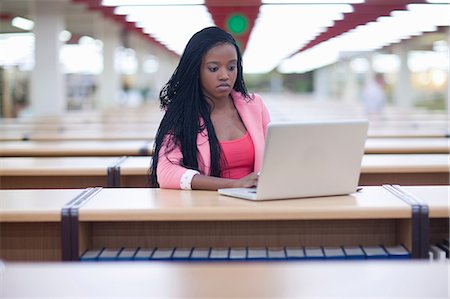 Female student studying in library Stock Photo - Premium Royalty-Free, Code: 614-06973872