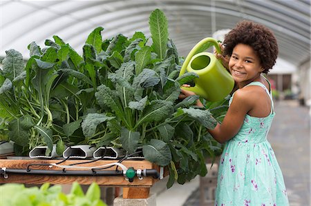 simsearch:614-06974033,k - Girl watering plants in greenhouse Stock Photo - Premium Royalty-Free, Code: 614-06973999