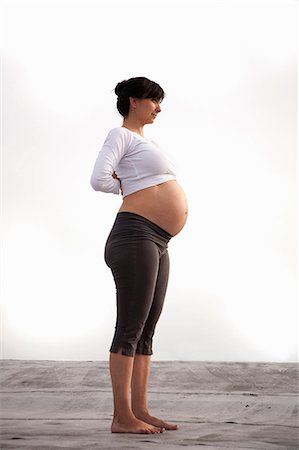 pregnant exercising - Pregnant woman in yoga mountain pose Stock Photo - Premium Royalty-Free, Code: 614-07031102