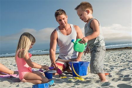 father and kid at the beach - Young man playing with son and daughter on beach Stock Photo - Premium Royalty-Free, Code: 614-07031177