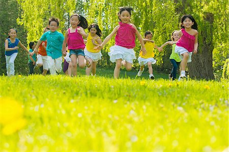 people at park - Children running on grass Stock Photo - Premium Royalty-Free, Code: 614-07031199
