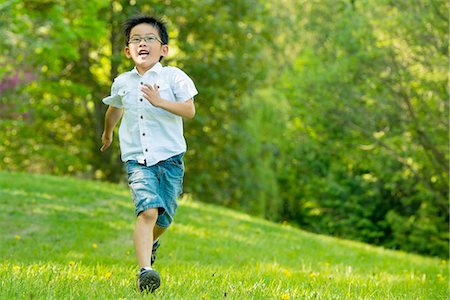 running kids frontal - Boy running on grass Stock Photo - Premium Royalty-Free, Code: 614-07031215