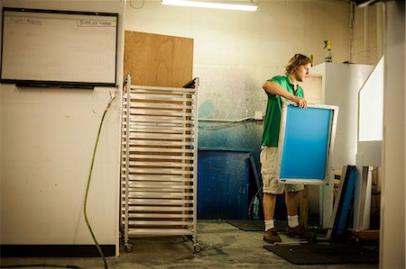 Man holding frame in screen print workshop Stock Photo - Premium Royalty-Free, Code: 614-07031279