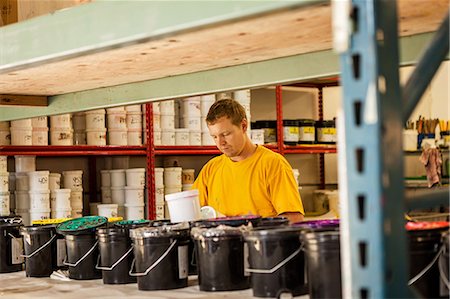 storage (industrial and commercial) - Man checking ink in screen print workshop Stock Photo - Premium Royalty-Free, Code: 614-07031282