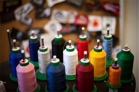 Group of embroidery thread bobbins on machine Stock Photo - Premium Royalty-Free, Code: 614-07031308