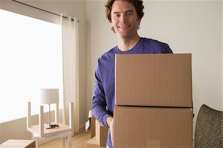 Portrait of mature man holding cardboard boxes Stock Photo - Premium Royalty-Free, Code: 614-07031320