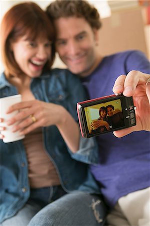 redhead woman 40s smiling - Couple taking self portrait whilst moving house Stock Photo - Premium Royalty-Free, Code: 614-07031339