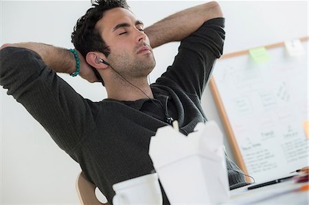 fatigued - Portrait of male listening to earphones Stock Photo - Premium Royalty-Free, Code: 614-07031401