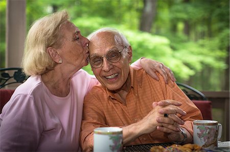 senior couple retirement - Senior woman kissing man, smiling Stock Photo - Premium Royalty-Free, Code: 614-07031431