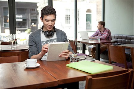 simsearch:614-07031529,k - Young man with digital tablet in cafe Stock Photo - Premium Royalty-Free, Code: 614-07031558