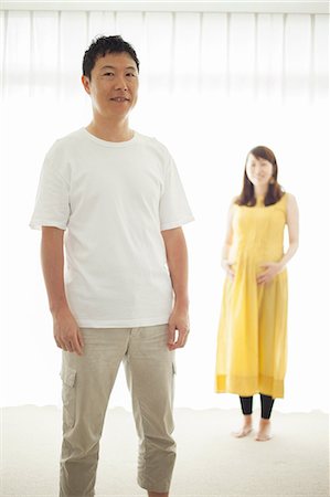 simsearch:614-07031597,k - Man with pregnant woman in background, portrait Stock Photo - Premium Royalty-Free, Code: 614-07031598