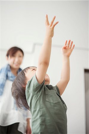 Boy reaching with arms up Stock Photo - Premium Royalty-Free, Code: 614-07031617