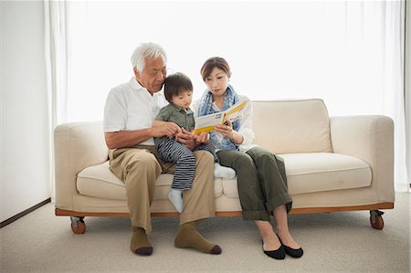 Mother reading to son sitting on grandfather's lap Photographie de stock - Premium Libres de Droits, Code: 614-07031631