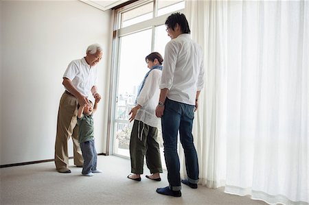 simsearch:614-07031643,k - Three generation family standing by window Stock Photo - Premium Royalty-Free, Code: 614-07031643