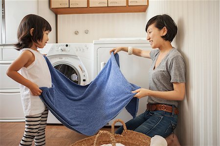 people working together - Mother and daughter folding towel Stock Photo - Premium Royalty-Free, Code: 614-07031659