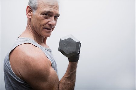 senior lifting dumbbell - Senior man lifting dumbbell, portrait Stock Photo - Premium Royalty-Free, Code: 614-07031738