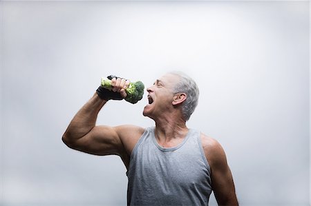 fit - Senior man about to eat broccoli Stock Photo - Premium Royalty-Free, Code: 614-07031741