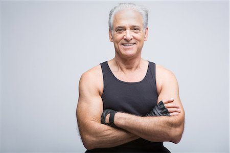 Senior man in sports clothing with arms crossed, portrait Stock Photo - Premium Royalty-Free, Code: 614-07031758