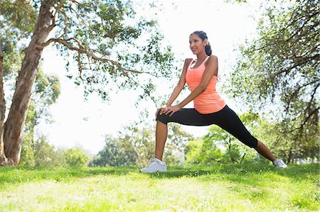pêche (fruit) - Young woman stretching in park Photographie de stock - Premium Libres de Droits, Code: 614-07031776