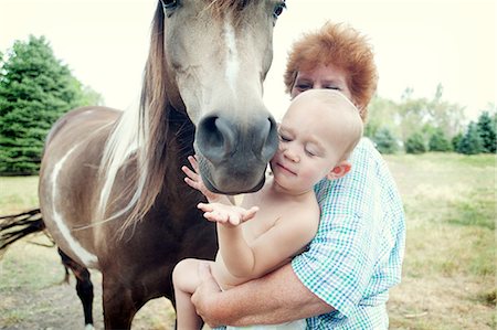 Grandmother and toddler with horse Fotografie stock - Premium Royalty-Free, Codice: 614-07031819