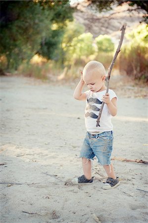 Young male toddler with stick Stock Photo - Premium Royalty-Free, Code: 614-07031822
