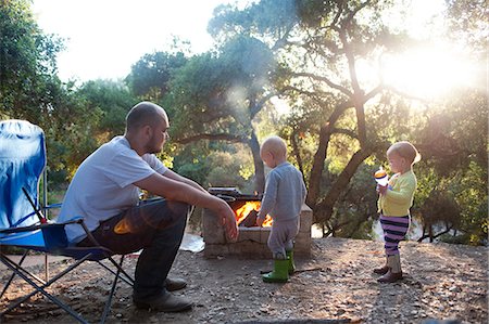 fire camp - Toddler twins on camping site with father Stock Photo - Premium Royalty-Free, Code: 614-07031830