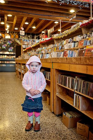 Young girl standing in store, portrait Stock Photo - Premium Royalty-Free, Code: 614-07031883