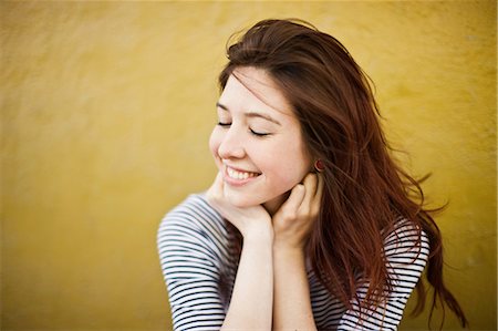 smiling brunette woman - Candid portrait of young woman with eyes closed Stock Photo - Premium Royalty-Free, Code: 614-07031914