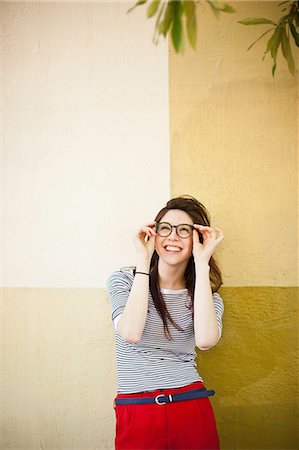 eyeglasses outdoor - Portrait of young woman in front of color divided wall Stock Photo - Premium Royalty-Free, Code: 614-07031913