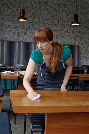 Mid adult woman cleaning table in restaurant Stock Photo - Premium Royalty-Free, Code: 614-07032196