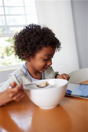 simsearch:614-07145702,k - Boy eating breakfast and using digital tablet Stock Photo - Premium Royalty-Free, Code: 614-07145708