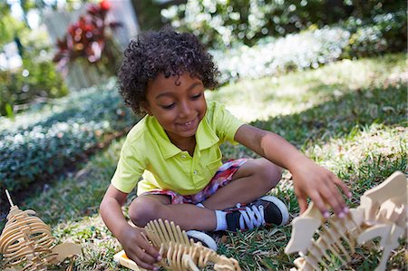 simsearch:614-07145702,k - Boy playing with dinosaur skeleton toys Stock Photo - Premium Royalty-Free, Code: 614-07145703