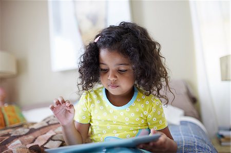 simsearch:614-07145702,k - Child sitting on bed using digital tablet Stock Photo - Premium Royalty-Free, Code: 614-07145712