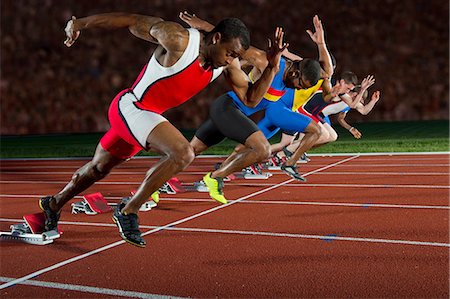 running track race - Athletes at start line of race Stock Photo - Premium Royalty-Free, Code: 614-07145730