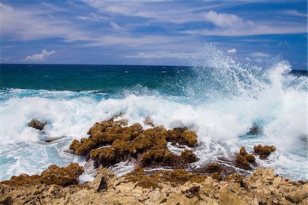 Waves crashing over rocks, Palm Beach, Oranjestad, Aruba Stock Photo - Premium Royalty-Free, Code: 614-07145776