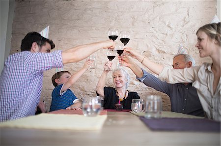 Family toasting with red wine at dinner table Stock Photo - Premium Royalty-Free, Code: 614-07145925