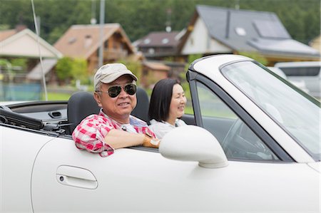 relaxed retirement - Couple enjoying leisurely drive in sports car Stock Photo - Premium Royalty-Free, Code: 614-07145935