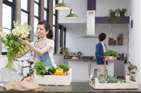 Young couple in kitchen preparing meal Stock Photo - Premium Royalty-Free, Code: 614-07146151