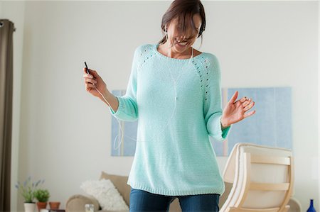 single women dancing indoor - Mature dancing with mp3 player Stock Photo - Premium Royalty-Free, Code: 614-07146214