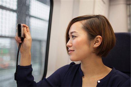 simsearch:614-02838620,k - Young woman taking photo through train window Stock Photo - Premium Royalty-Free, Code: 614-07146517