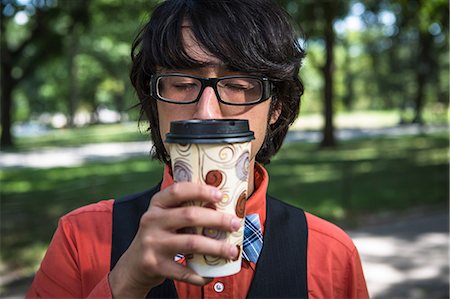 simsearch:614-07146671,k - Young man inhaling coffee from disposable cup Photographie de stock - Premium Libres de Droits, Code: 614-07146666