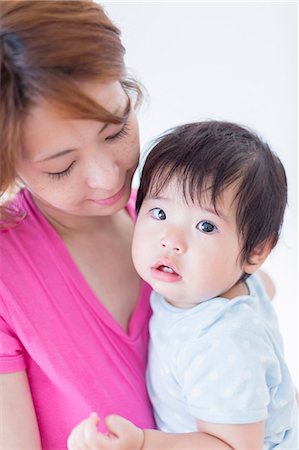 family and toddler - Mother looking down at baby in arms Stock Photo - Premium Royalty-Free, Code: 614-07194405