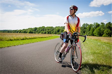 simsearch:614-07194427,k - Senior man riding bicycle through countryside Stock Photo - Premium Royalty-Free, Code: 614-07194428