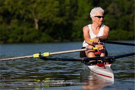 Senior woman rowing in rowing boat Stock Photo - Premium Royalty-Free, Code: 614-07194433