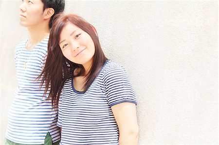 ethnic couple white background - Portrait of young couple wearing striped top garments Stock Photo - Premium Royalty-Free, Code: 614-07194468