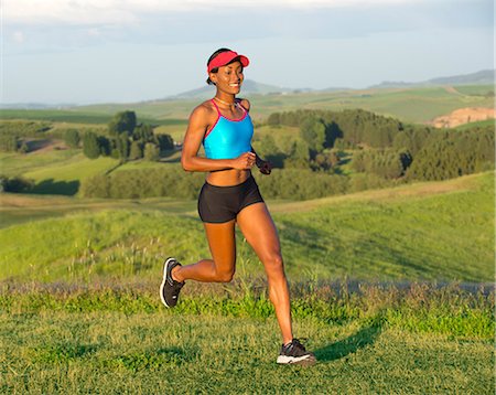 Young woman running in landscape, Othello, Washington, USA Stock Photo - Premium Royalty-Free, Code: 614-07194644